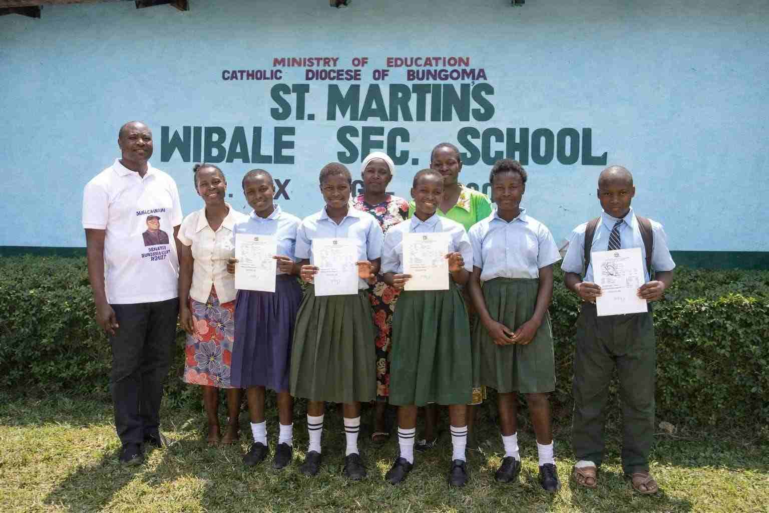 Students holding KCSE results certificates at Mwibale Senior School Bungoma