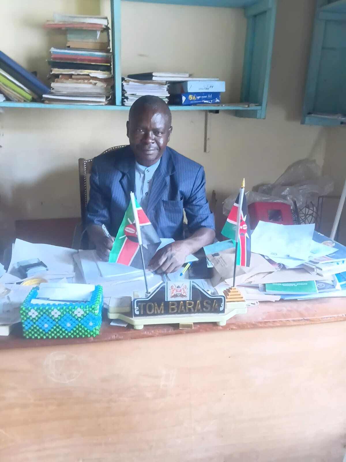 Deputy Principal Mr. Tom Barasa at his office desk at Mwibale Senior School